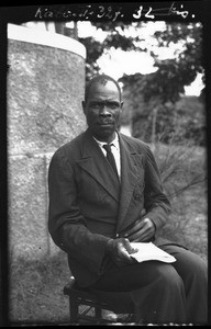 African man sitting on a stool, Mozambique, ca. 1940-1950