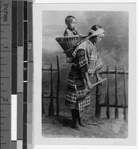 Igorot girl carrying a child in a basket, Baguio, Philippines, ca. 1920-1930
