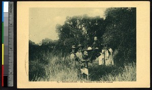 Seated missionary priest carried by four men, Madagascar, ca.1920-1940