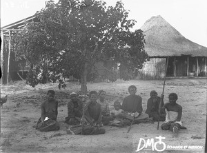 African women sitting in front of a tree