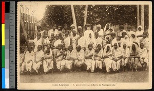 Missionary sister standing among a gathering of white-clad women, India, ca.1920-1940