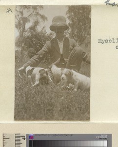 Myself in the garden with our puppies, Tanzania, ca.1888-1929