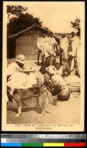 Father Lievens giving rice to school boys, Torpa, India, ca.1920-1940