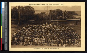 Missionaries pose with a large group of young students, Porto-Novo, Benin, ca. 1900-1930