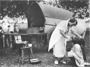 Female medical missionary administering to a patient by roadside, India, ca. 1936-1941