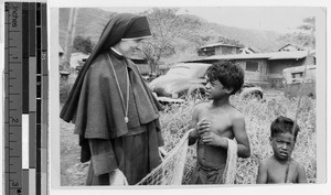 Sister Joan Petrik, MM, talking to two boys, Kaneohe, Hawaii, 1949