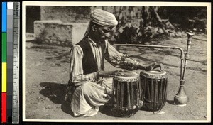 Musician playing drums, Punjab, India, ca.1920-1940