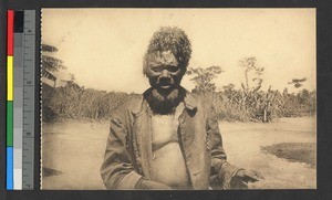 Man with beard and braided hair standing outdoors, Congo, ca.1920-1940