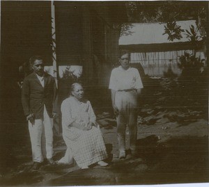 Three lepers in front of their kitchen