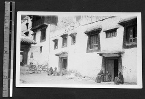 Monks sitting in the courtyard of the Tsakulao lamasery, Sichuan, China, ca.1927