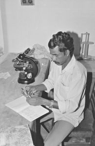 Danish Bangladesh Leprosy Mission/DBLM, Nilphamari, 1981. Mr. Biswanath Hansdak on duty. Micros