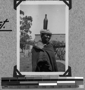 Fingu girl with medicine bottle on her head, South Africa East