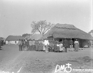 Group of African people standing in front of huts, Limpopo, South Africa, ca. 1896-1911