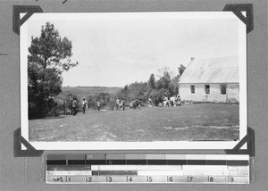 Groups of men, women and children next to a building, Wittekleibosch, South Africa, 1934