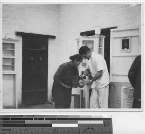 Dr. Blaber treats child at Dongan, China, 1931