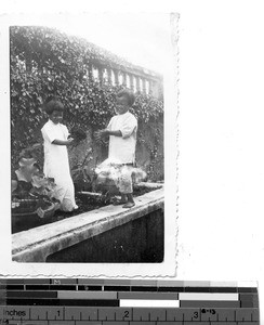 Two children with water lillies at Dongshi, China, 1937