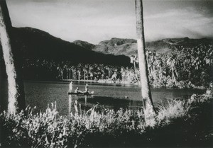 Fishermen in their outrigger canoes, in a bay, near Uturoa