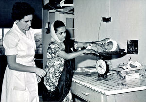 Affara Hospital. Sheikh Othman. 1971. Arabian mother is being instructed in child care. Nearly