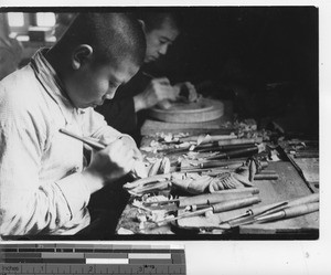 Chinese men carving religious art at Fushun, China, 1936