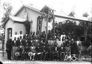 Group of men standing in front of a chapel, Pretoria, South Africa, ca. 1896-1911