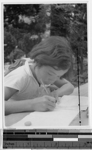 Japanese girl writing in a book, Japan, ca. 1938