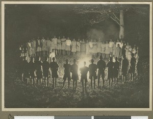 Singing a hymn around a camp fire, Eastern province, Kenya, September 1934