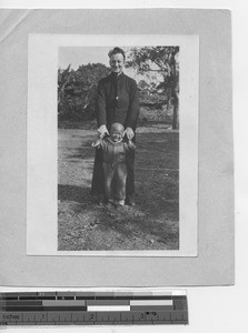 Fr. Taggart with a child at Dongzhen, China, 1924