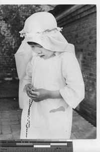 A Japanese girl receives First Communion at Japanese Mission at Fushun, China, 1940