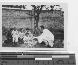 A Maryknoll priest with children at Rongxian, China, 1932