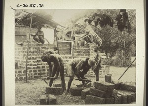 Masons building the church in Udapi, working on laterite