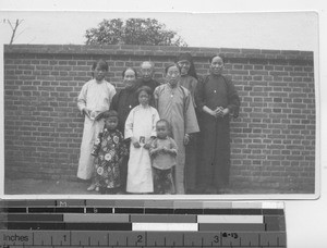 Sister Eunice with a new Christian family at Fushun, China, 1934