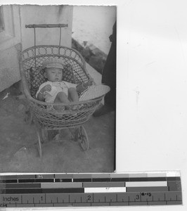 A child sleeping in a carriage at Chaoyangzhen, China, 1941