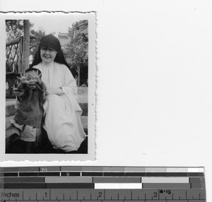 A Maryknoll Sister with an orphan at Luoding, China, 1937