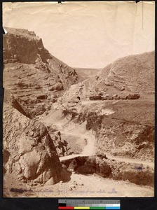 Train passing into a tunnel along a rocky hillside, Syria, ca.1856-1910