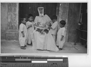 A sister holding triplets at Yuauling, China, 1939