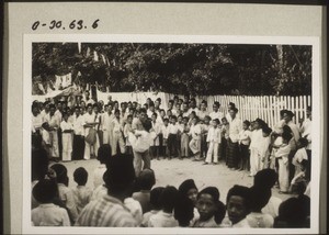 Phases of the mock-battle on the street which takes place before the bridegroom is allowed to go up into the house. Two boys wrestling