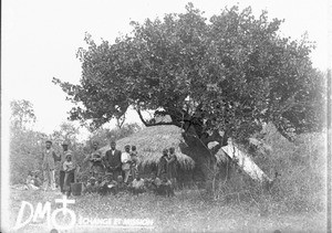 Group of people in front of a hut, Africa, ca. 1896-1911