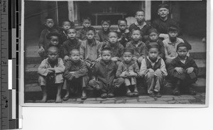 Reverend Robert J. Cairns and his pupils at the Holy Cross School, Fachow, China, 1924