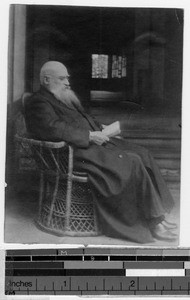 Fr. Aurientis reading a book, China, ca. 1917