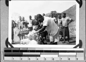 An African health assistant medicating, Nyasa, Tanzania, ca. 1938