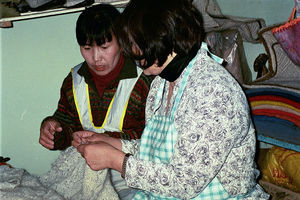 Kindergarden childrens mothers is being taught sewing and weaving to enable them to make a livi