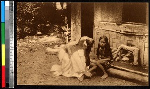 A missionary bandages a girl's ankle, India, ca.1920-1940