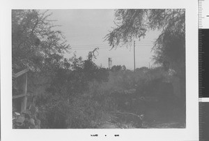 Man on hillside with water tower