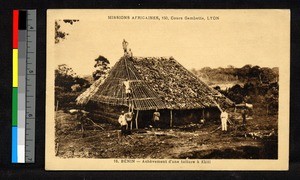 Men laboring to build a thatch-roofed building, Benin, ca.1920-1940