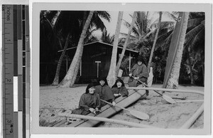 Maryknoll Sisters sitting in a canoe on Honaunau Beach, Hawaii, 1947