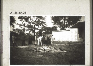 In front the little pile of ash and debris left from the destruction of the deities, behind a series of placards with the motto 'Remove the unequal treaties, so that imperialism can be uprooted. The Peoples' Party