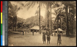 People standing before a small thatched school building, Congo, ca.1920-1940