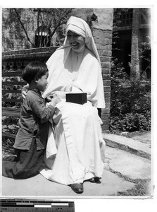 A Maryknoll Sister with a child in China