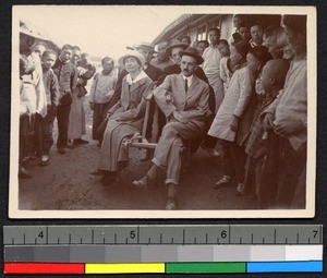 Frank and Verna Garrett, Dr. Peter, and Mr. Roger Green sitting near the boat landing, Nantong, Jiangsu, China, 1916