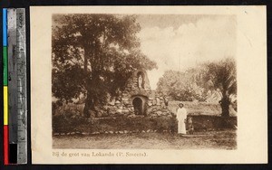 Missionary and child near a shrine, Lokandu, Congo, ca.1920-1940